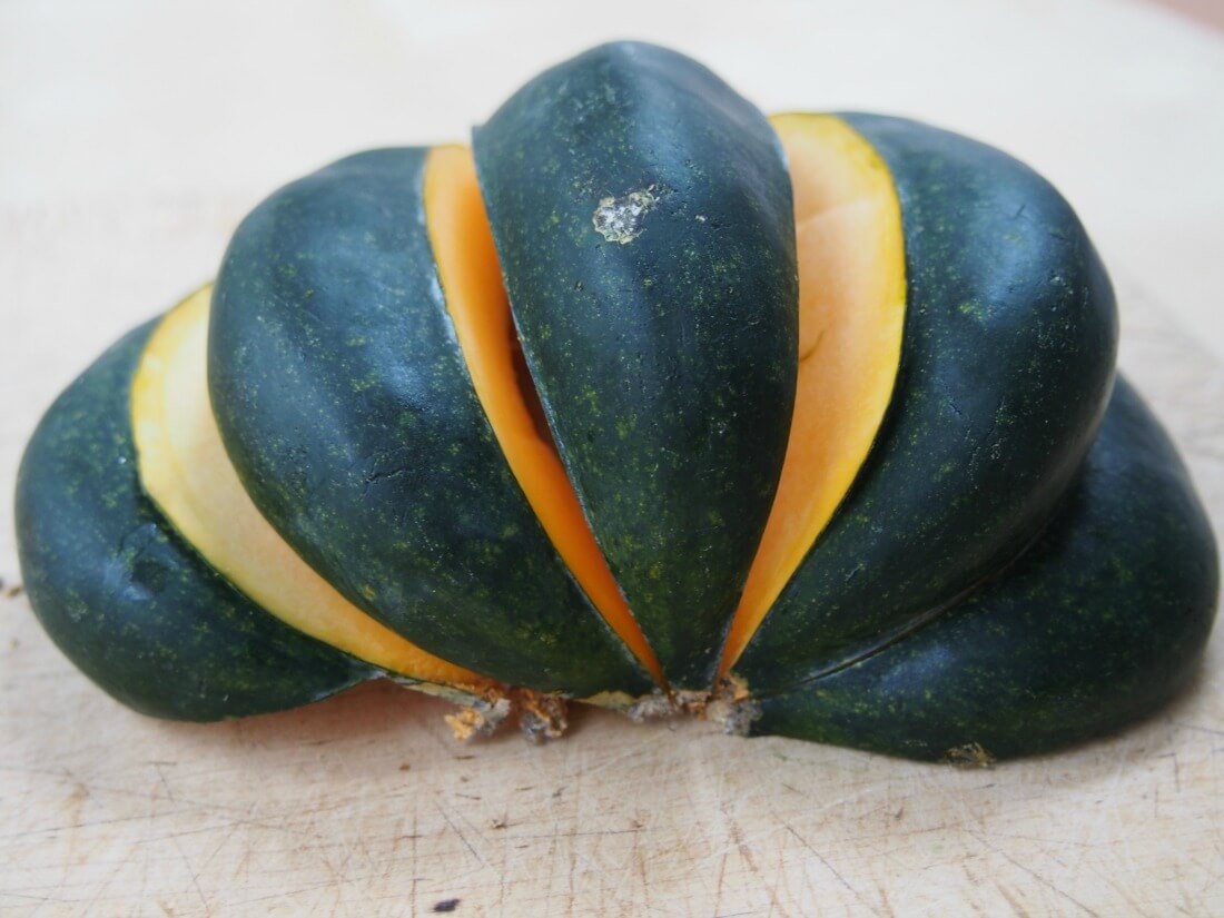acorn squash cut along ribs to make easier to peel