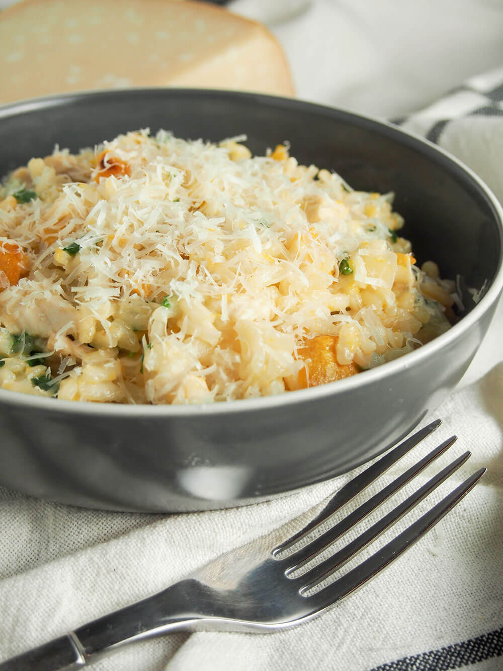 butternut squash risotto with chicken topped with parmesan