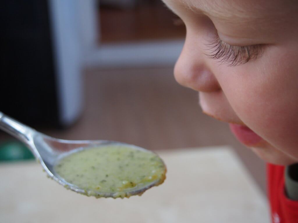 tasting pumpkin broccoli soup with cheddar