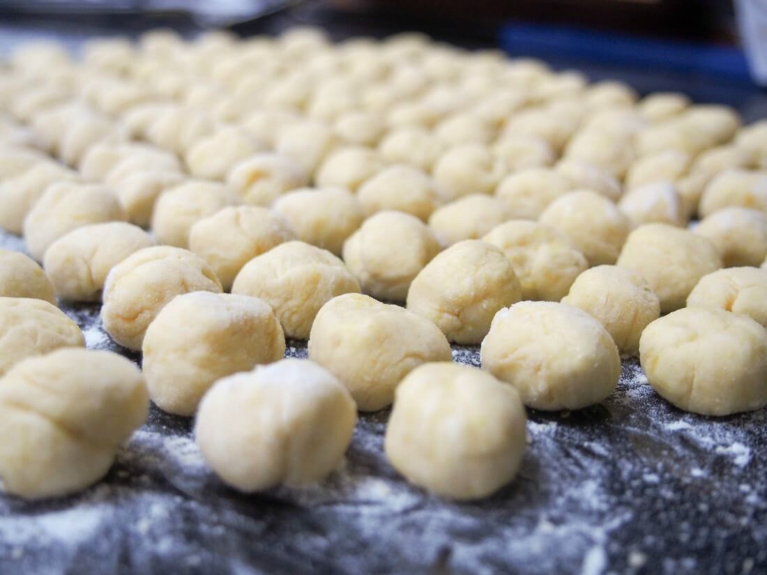 formed gnocchi on floured worktop ready to cook