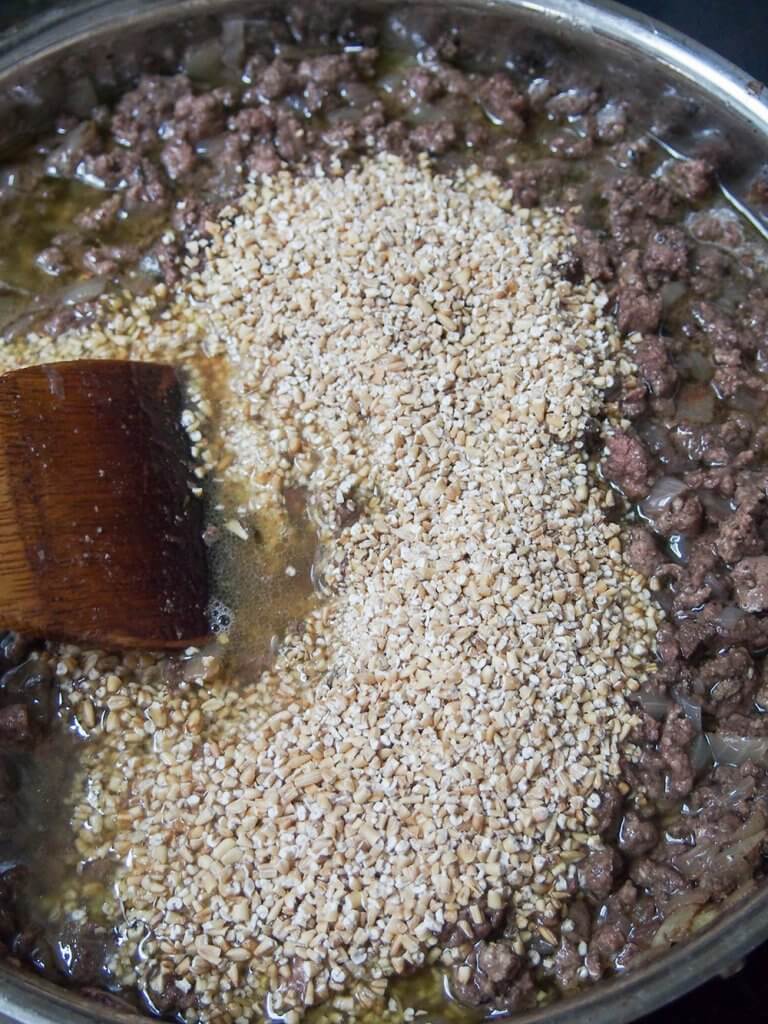 adding oatmeal to meat mixture