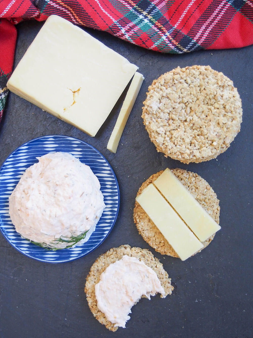 oatcakes viewed from overhead with some cheese on one of them and a dish with pate to one side