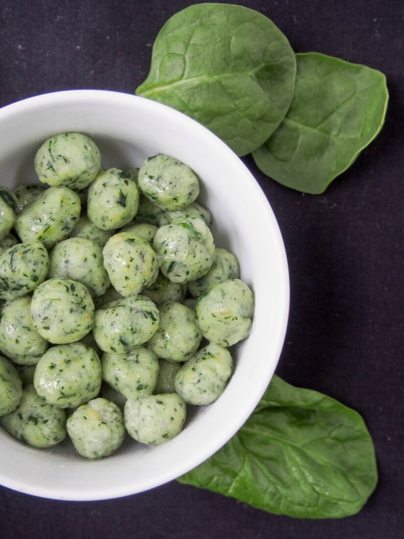 potato spinach gnocchi in bowl viewed from overhead