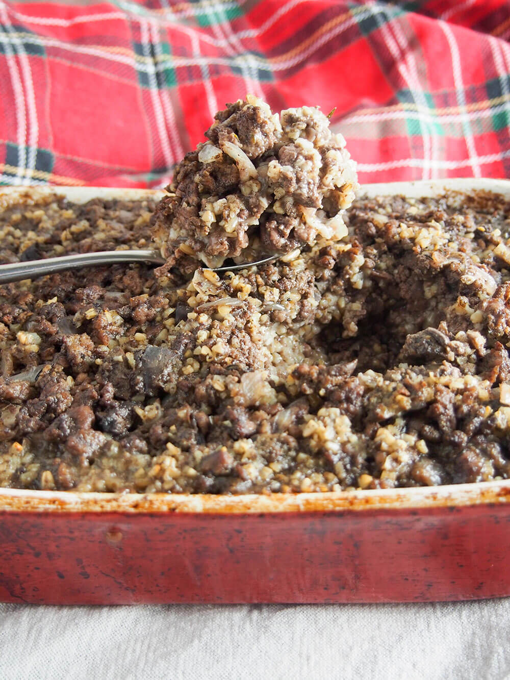 simplified haggis in dish with spoonful sitting on top