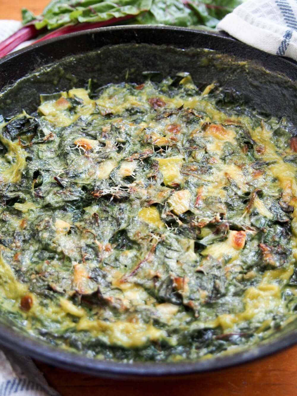 Leek and Swiss chard gratin close up in skillet