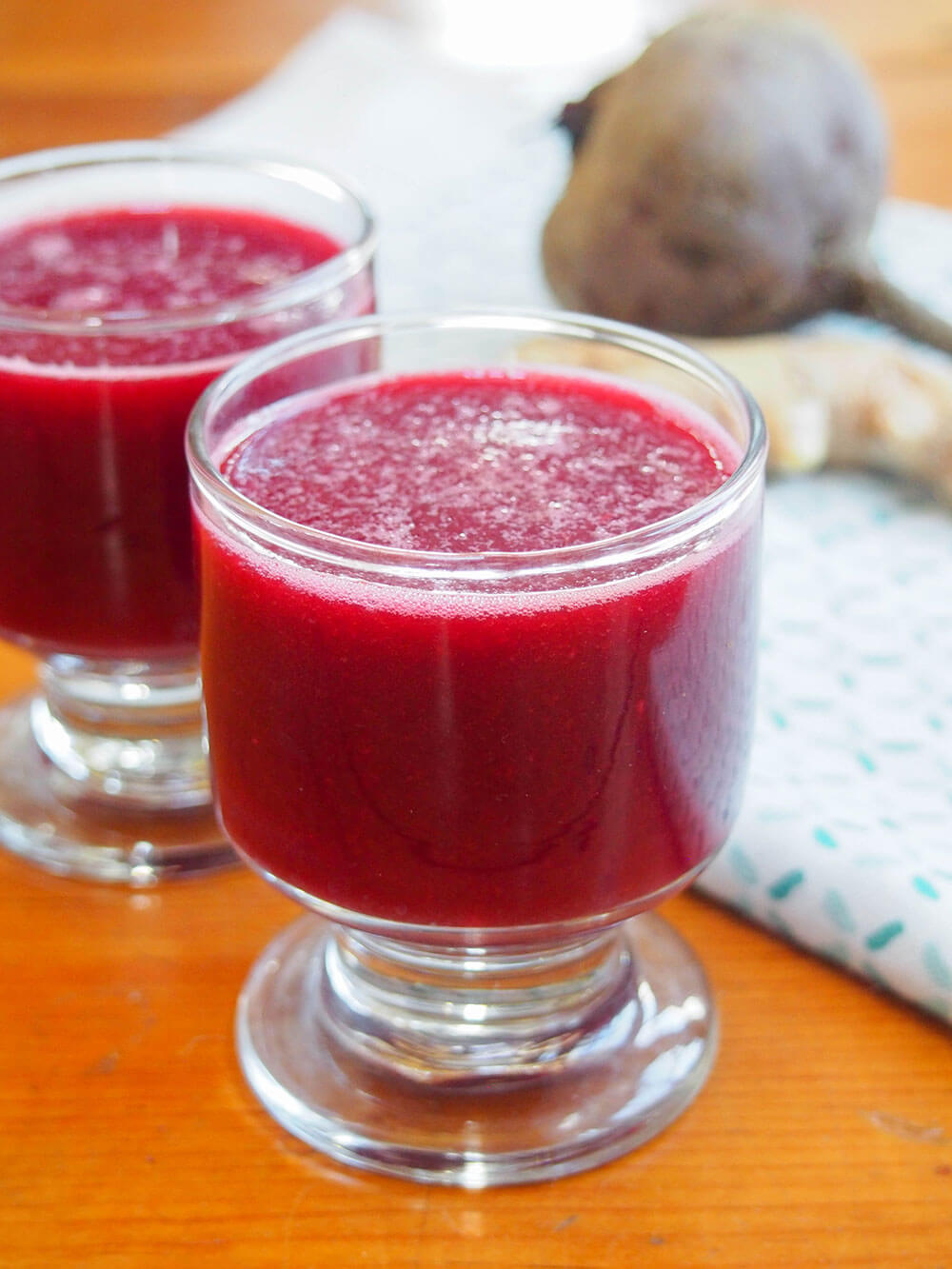 Glass of apple beet ginger juice from side