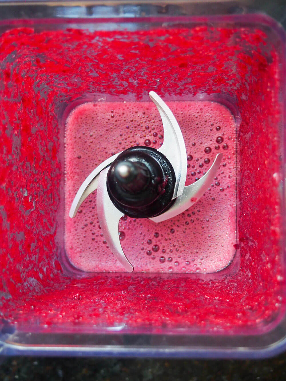 all of the ingredients blended together in blender to give bright purple liquid