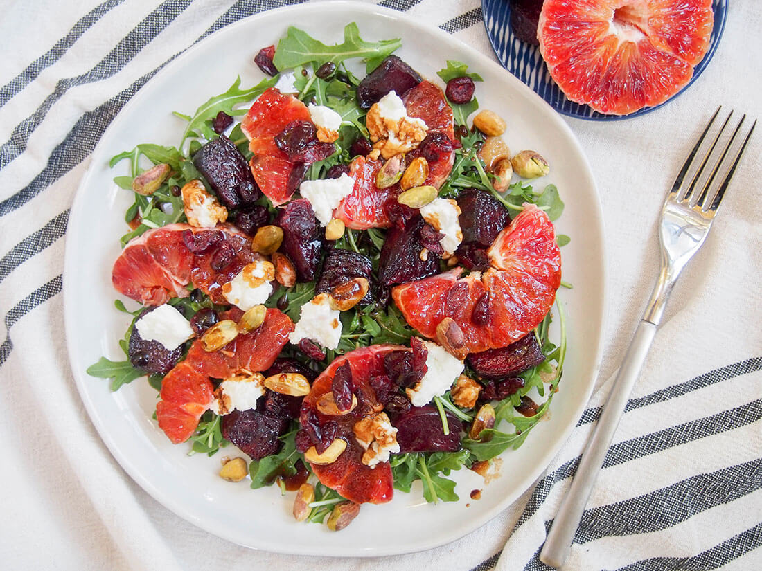 Beet and blood orange salad on plate with fork to side