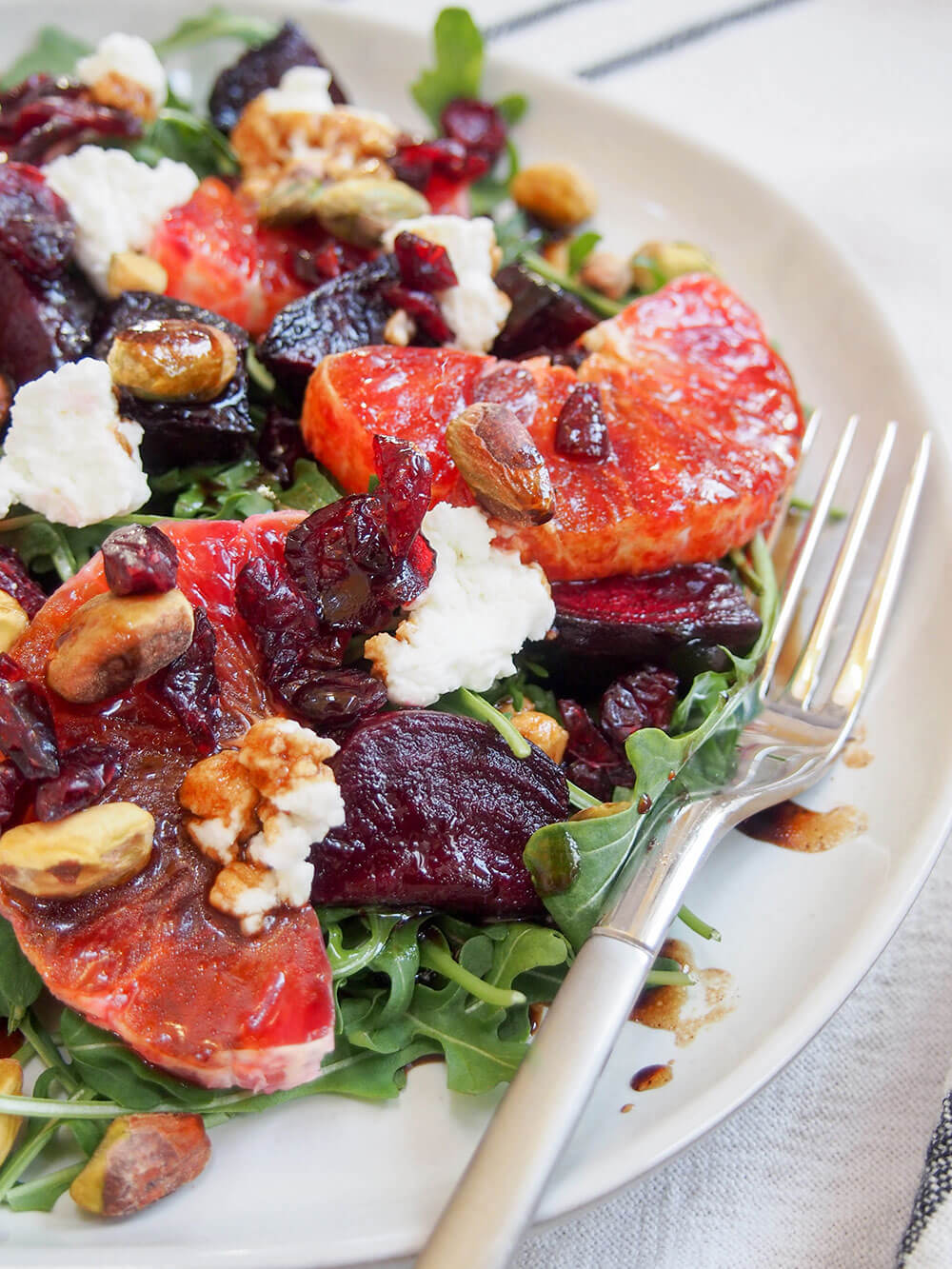 Beet and blood orange salad from side with fork on side of plate