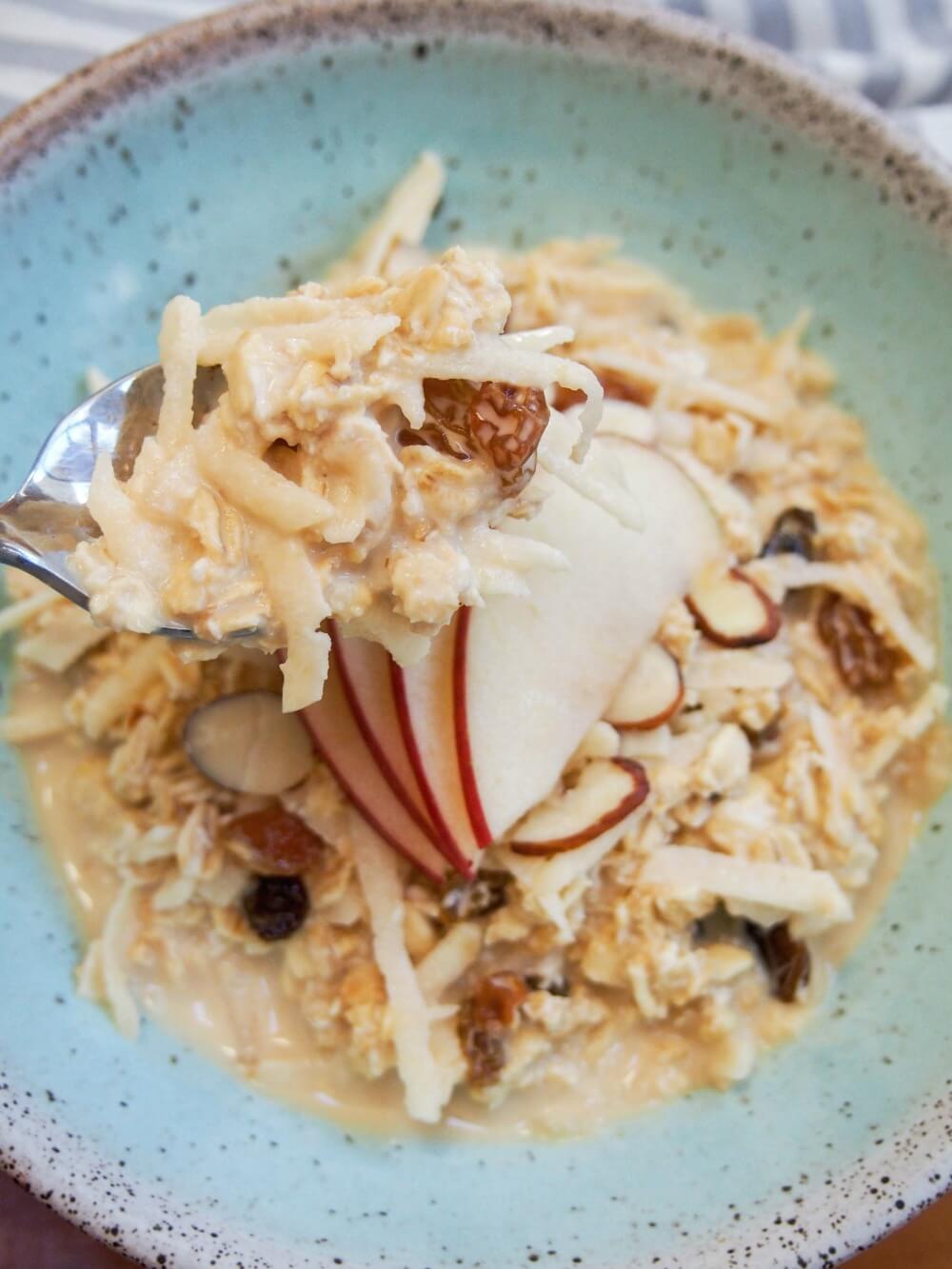 taking a spoonful of Swiss Bircher muesli