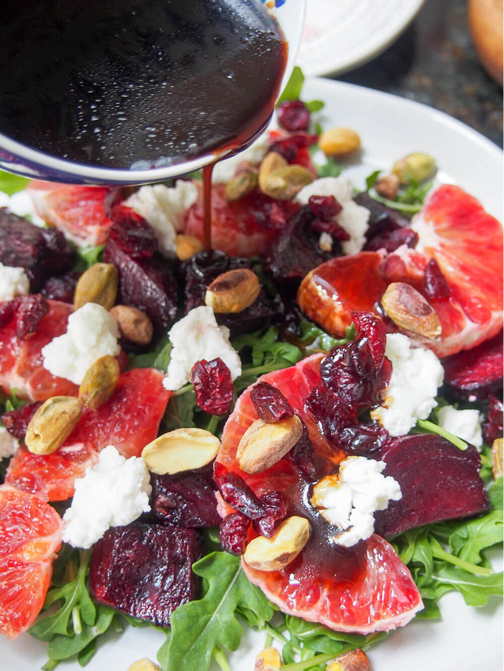 adding dressing to salad