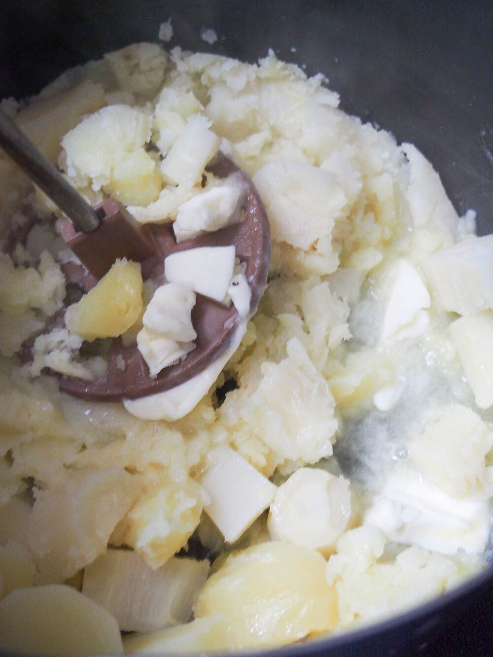 mashing vegetables for Parsnip and potato farl (potato scones)