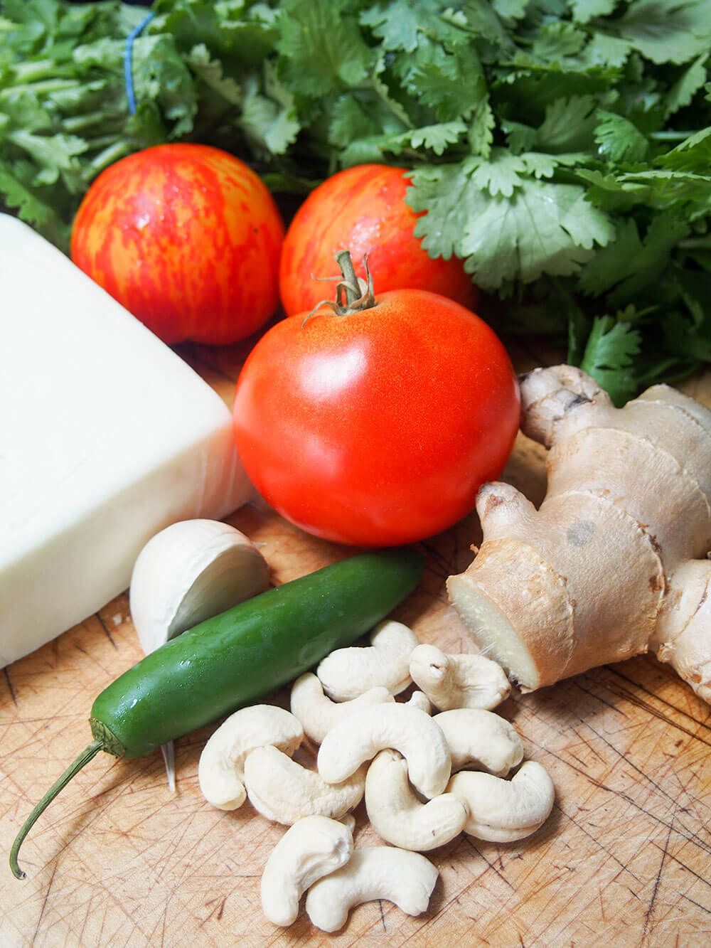 paneer Makhani ingredients - paneer, cashews, chili, garlic, tomato and cilantro