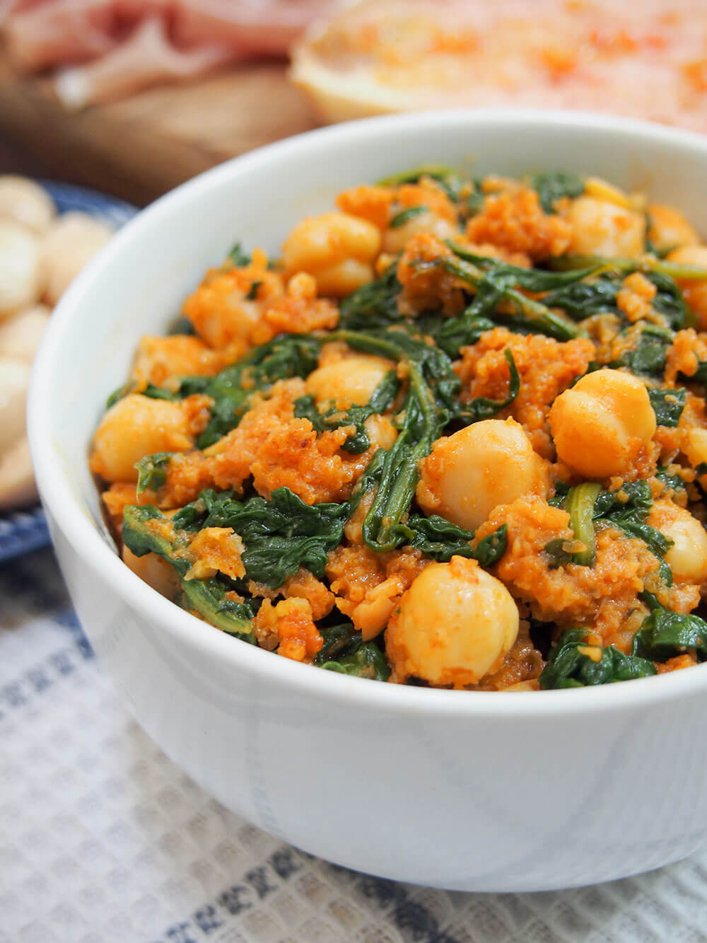 Spanish chickpeas and spinach in bowl viewed from side