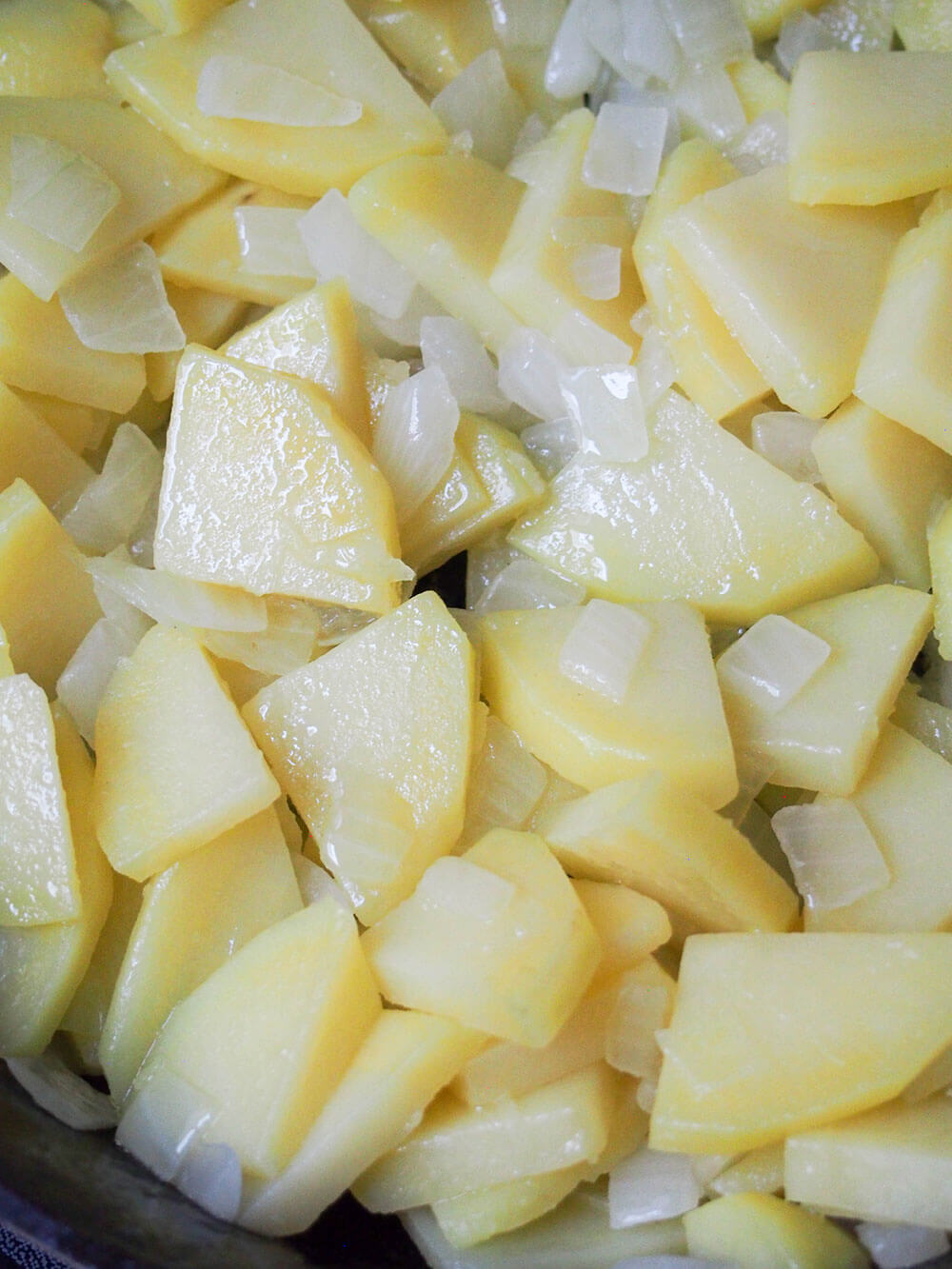 cooking potatoes and onion in skillet cooking potatoes and onion in skillet