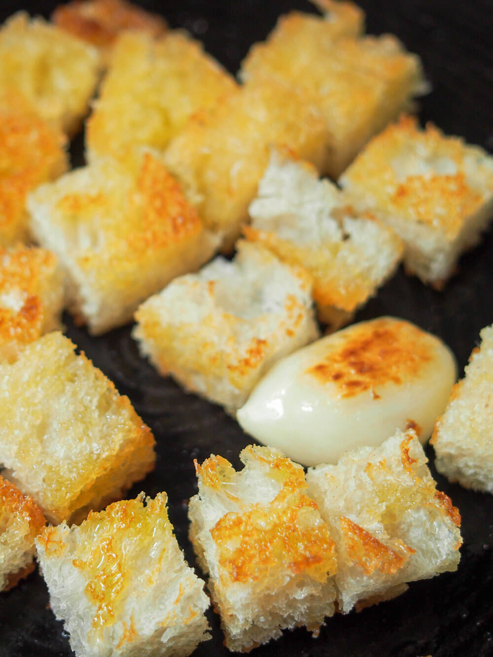 toasting bread and garlic in skillet