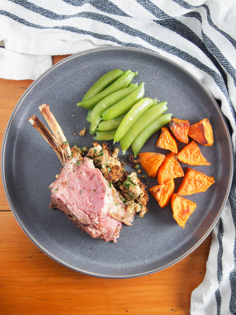Garlic herb crusted rack of lamb on plate
