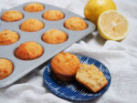 mini lemon almond flour muffins (or cupcakes) with one split open on plate