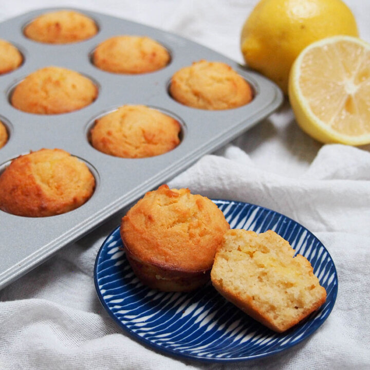 mini lemon almond flour muffins (or cupcakes) with one split open on plate