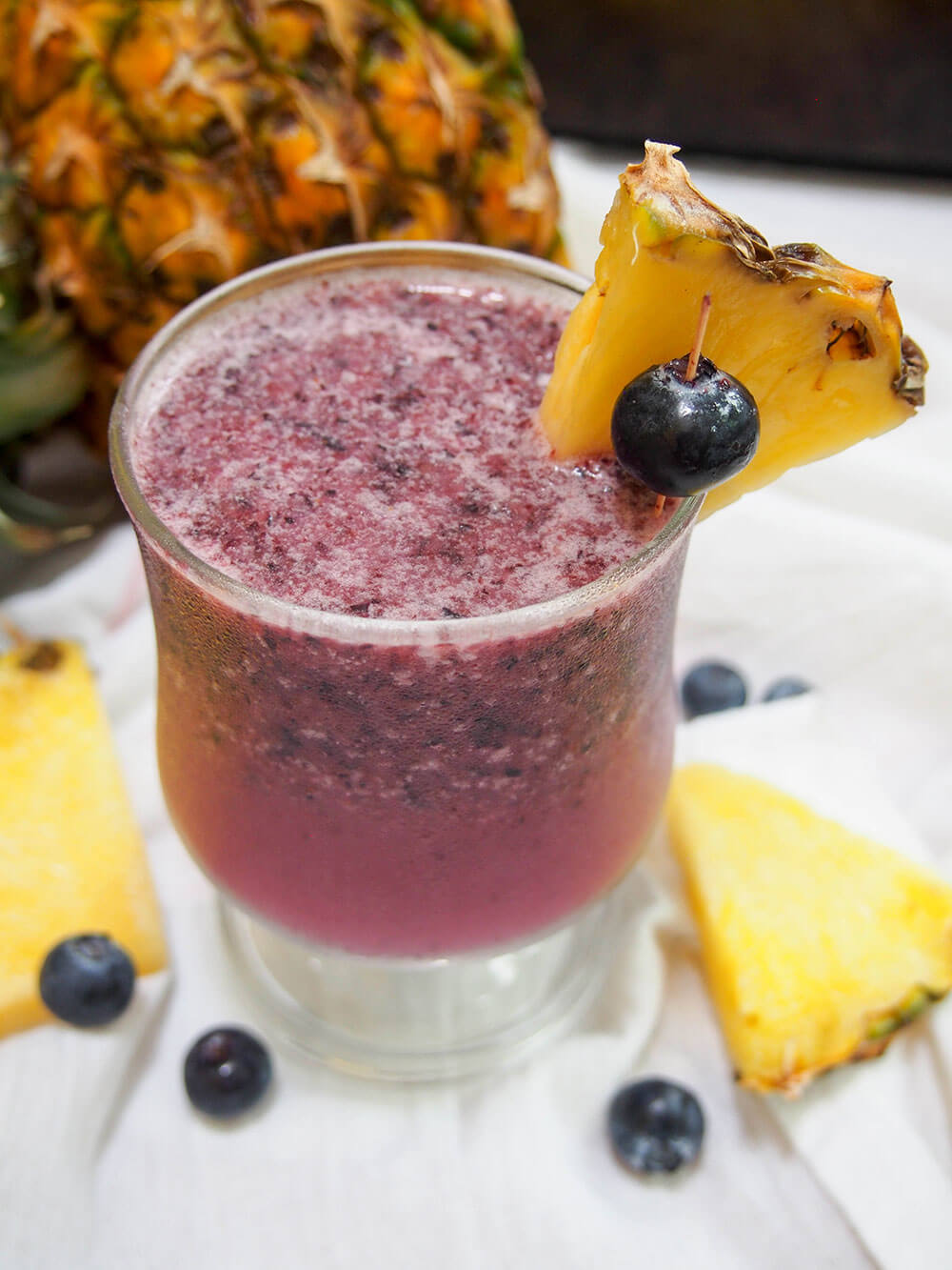 blueberry pina colada with blueberry and pineapple garnish