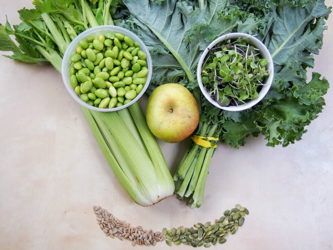 face shape made with kale, celery, seeds, apple, edamame, microgreens