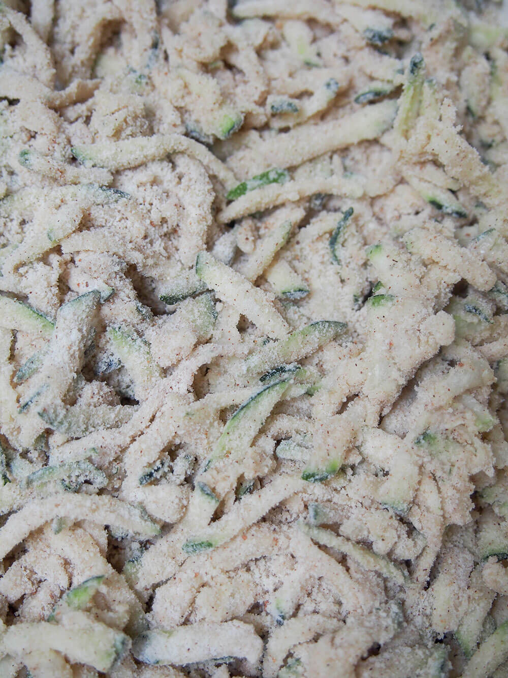 zucchini mixed through flour for Chocolate zucchini muffins (vegan)