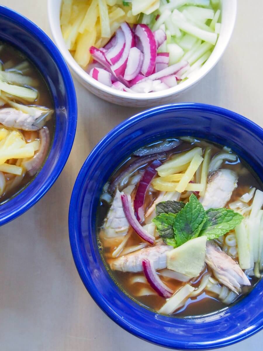 Asam laksa is a deliciously flavorful Asian broth with a spicy fish-tamarind base. It's served over rice noodles with cucumber, pineapple and mint garnish for a full meal in a bowl. This traditional Malaysian soup-like dish is perfect for any spice fans! Asam laksa is a deliciously flavorful Asian broth with a spicy fish-tamarind base. It's served over rice noodles with cucumber, pineapple and mint garnish for a full meal in a bowl. This traditional Malaysian soup-like dish is perfect for any spice fans!
