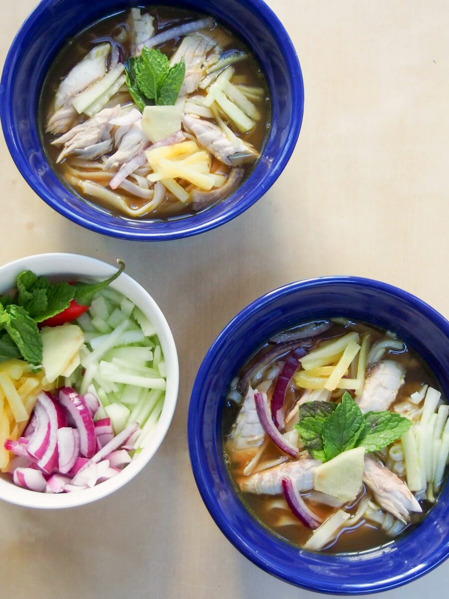 Asam laksa is a deliciously flavorful Asian broth with a spicy fish-tamarind base. It's served over rice noodles with cucumber, pineapple and mint garnish for a full meal in a bowl. This traditional Malaysian soup-like dish is perfect for any spice fans! asam laksa