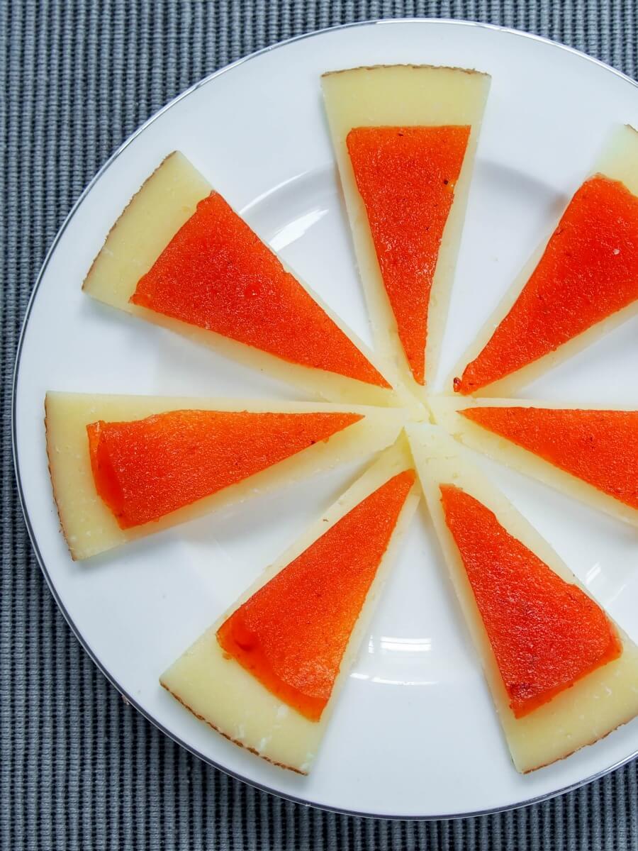 manchego cheese slices topped with membrillo (quince paste) pieces