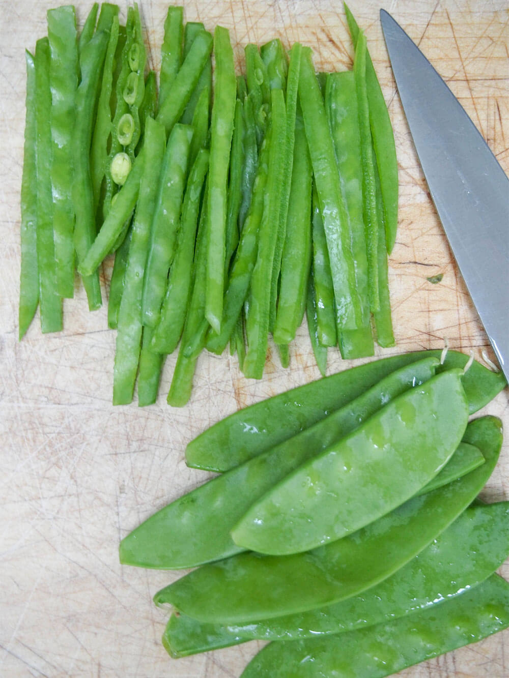 slicing snow peas for rainbow slaw slicing snow peas