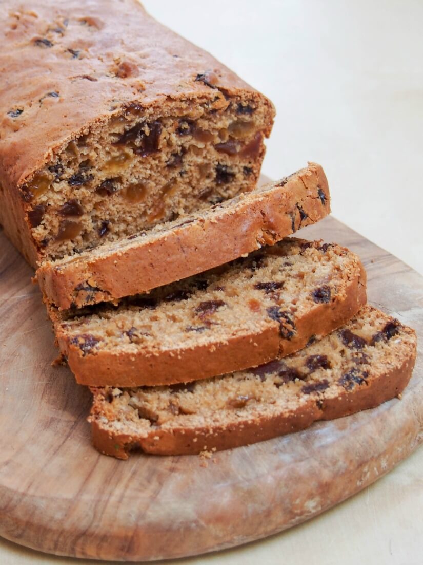Irish brack (barmbrack) is a traditional fruit loaf where the fruit is soaked in sweet tea before making a quick bread. It's a perfect treat with your tea/coffee. Irish brack (fruit loaf) with slices laying on each other in front of loaf