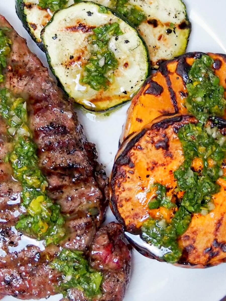 close up of grilled butternut squash, zucchini & steak with chimichurri sauce
