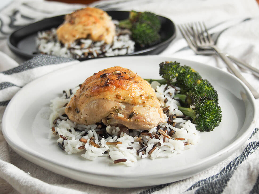 Incredibly easy to prepare, this baked tarragon chicken has a light, delicate and delicious flavor from the tarragon, lemon and mustard sauce. baked tarragon chicken on plate served over rice and with broccoli to side
