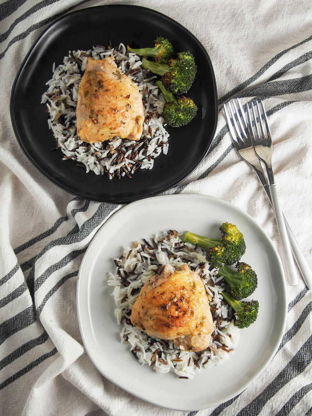 Incredibly easy to prepare, this baked tarragon chicken has a light, delicate and delicious flavor from the tarragon, lemon and mustard sauce. 2 plates of finished dish with forks to side from overhead