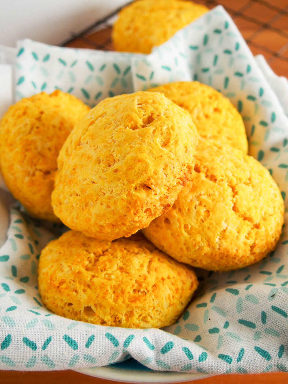 stack of butternut squash biscuits with gruyere in cloth-lined basket