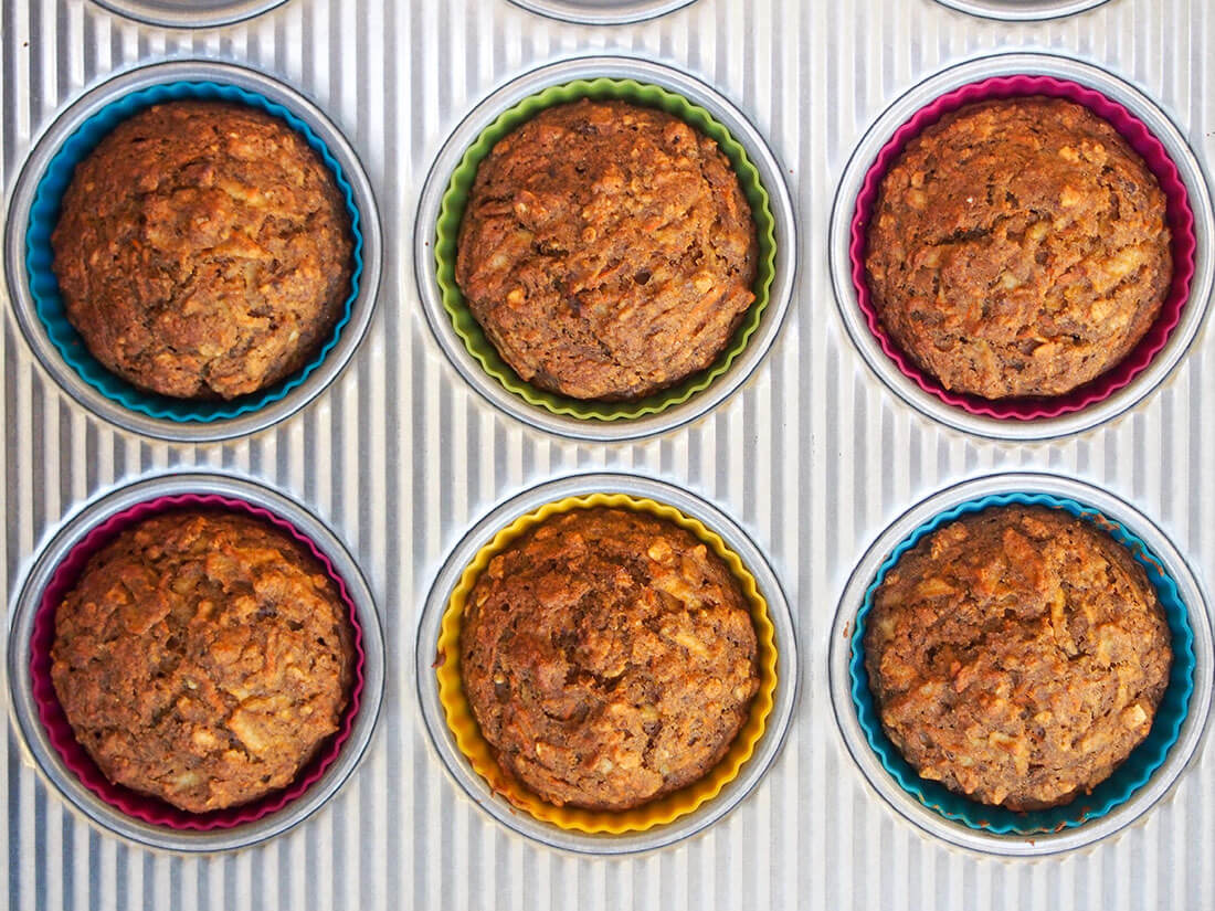 These naturally-sweetened carrot apple muffins have a delicious, gently spiced flavor and moist texture. They're easy to make and perfect for breakfast or a snack. Healthy carrot apple muffins in tin, just out oven