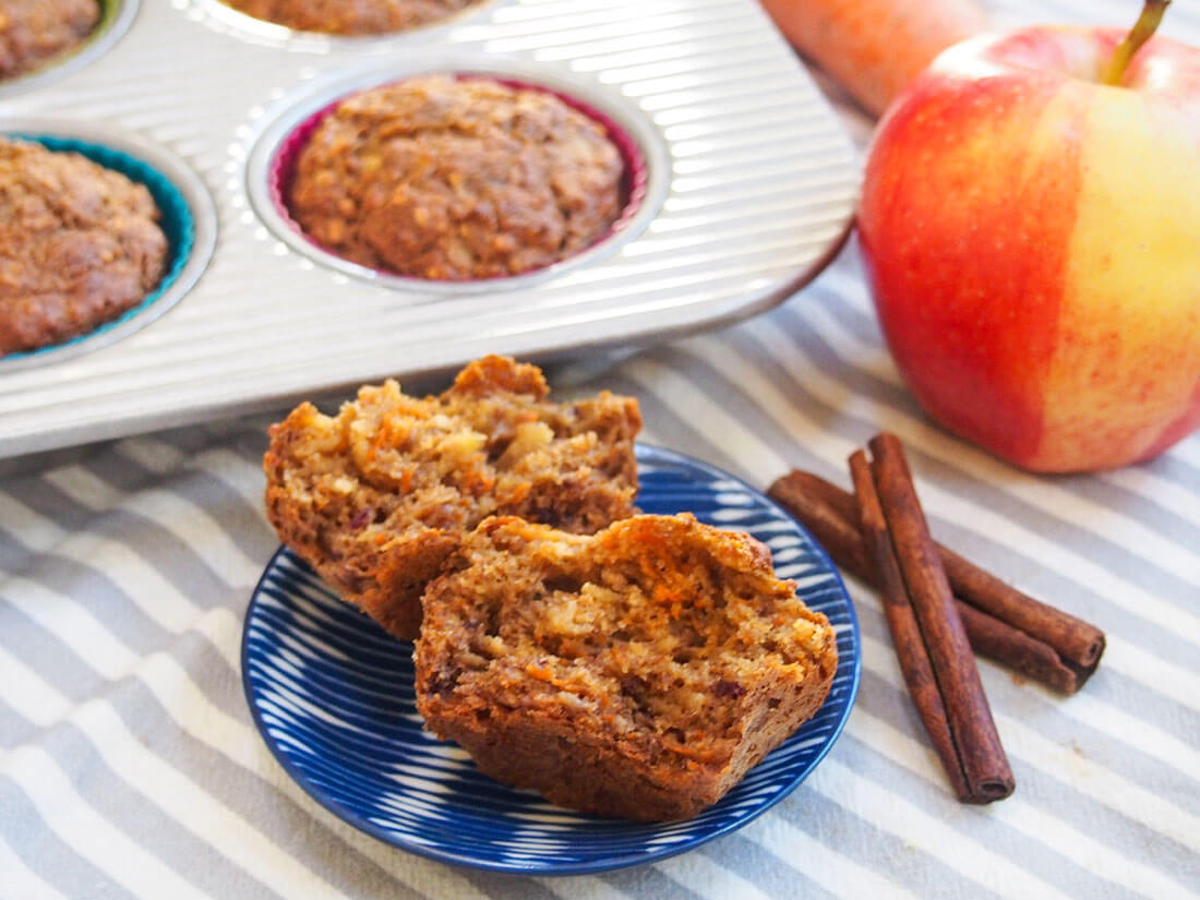 These naturally-sweetened carrot apple muffins have a delicious, gently spiced flavor and moist texture. They're easy to make and perfect for breakfast or a snack. Healthy carrot apple muffins with one split in front