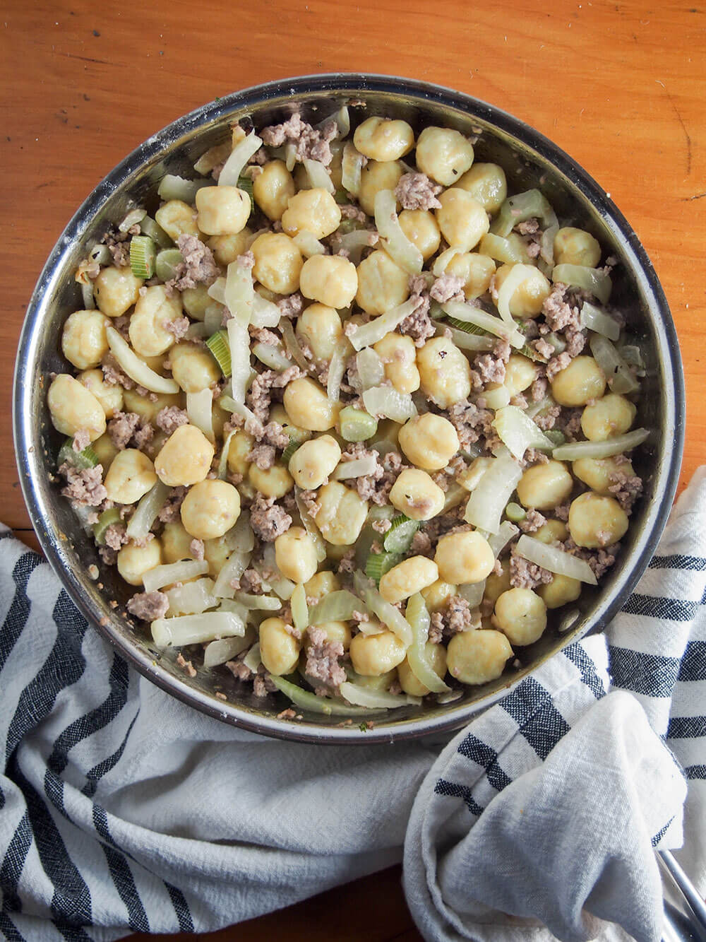 gnocchi with pork and fennel in skillet