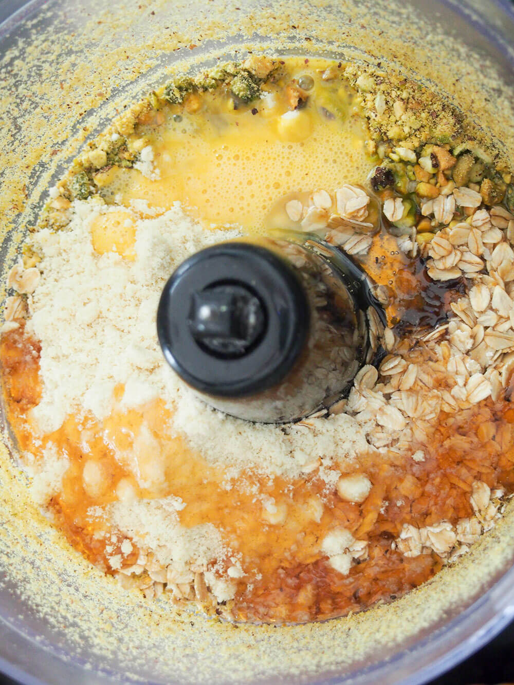 mixing oatmeal pistachio cookies ingredients in food processor