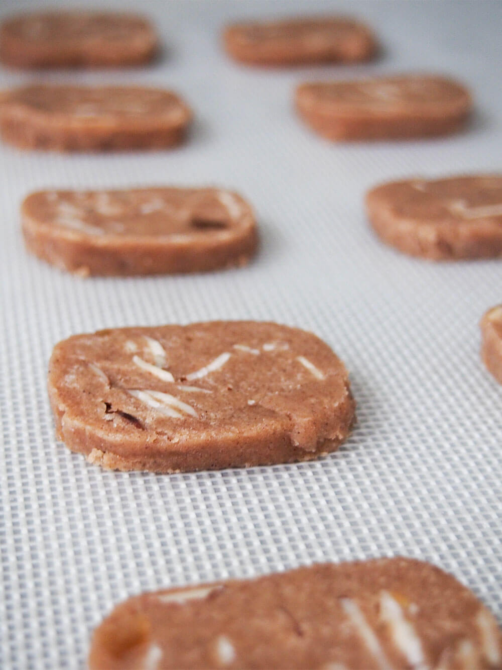 sliced brunkager on lined baking sheet ready to bake