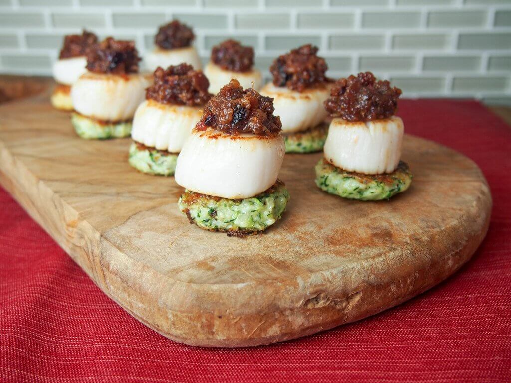 Scallops with cranberry bacon jam make for a stunning and delicious appetizer. Perfect for holiday entertaining or any excuse.