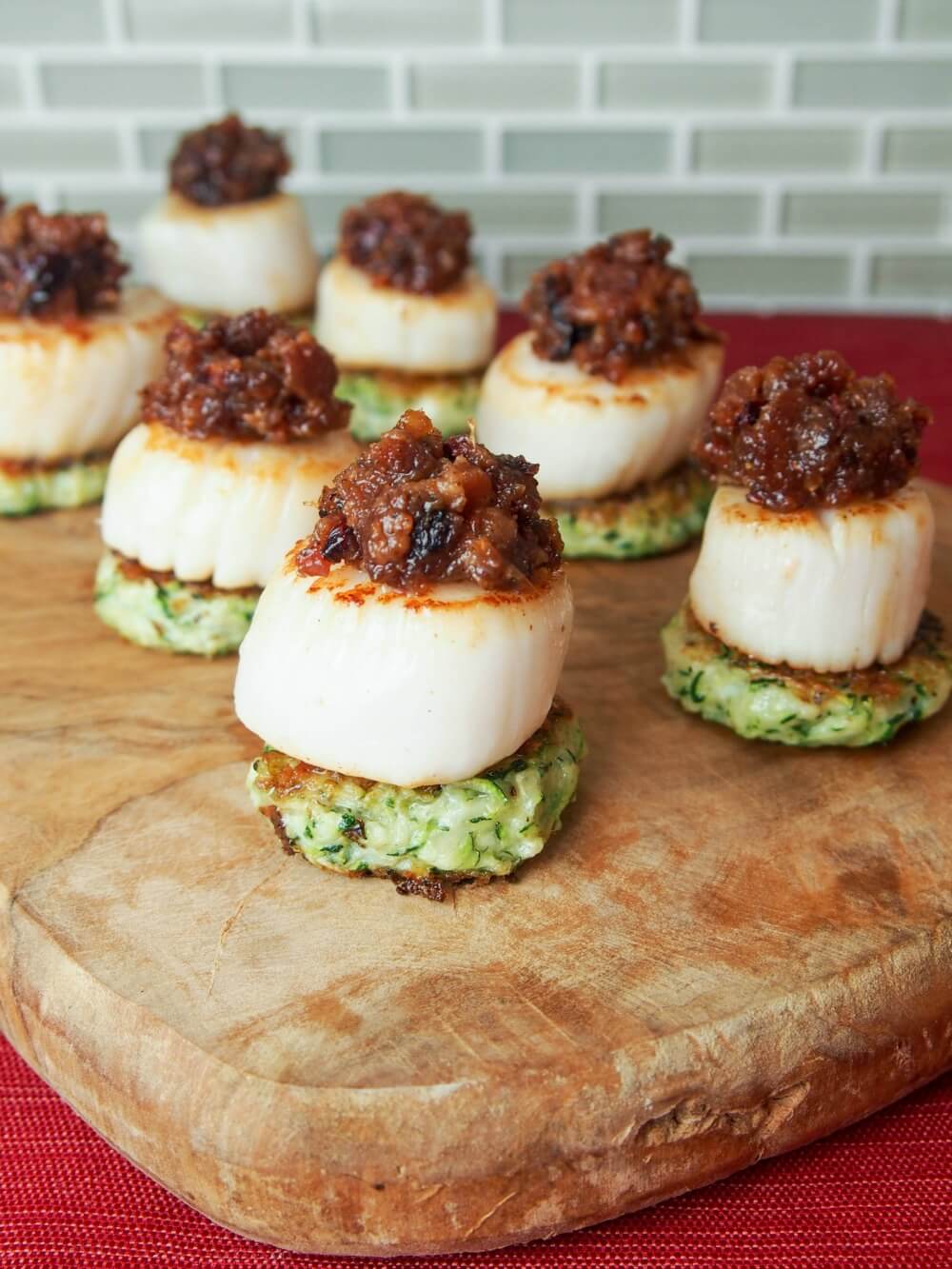 Scallops with cranberry bacon jam make for a stunning and delicious appetizer. Perfect for holiday entertaining or any excuse.