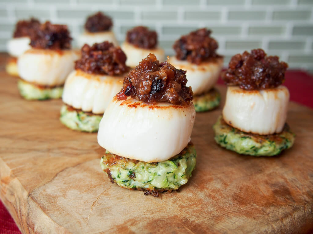 Scallops with cranberry bacon jam make for a stunning and delicious appetizer. Perfect for holiday entertaining or any excuse.