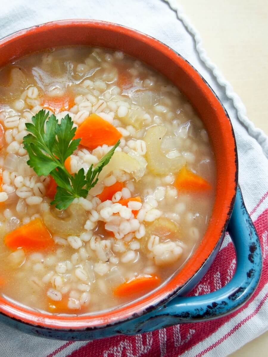 bowl of Scotch broth garnished with parsley from overhead