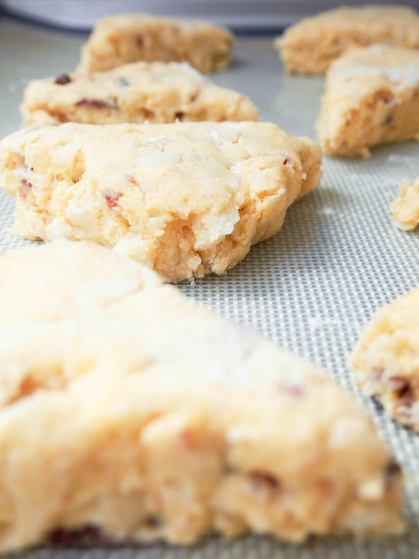 Apple and bacon cornmeal scones on baking sheet before baking