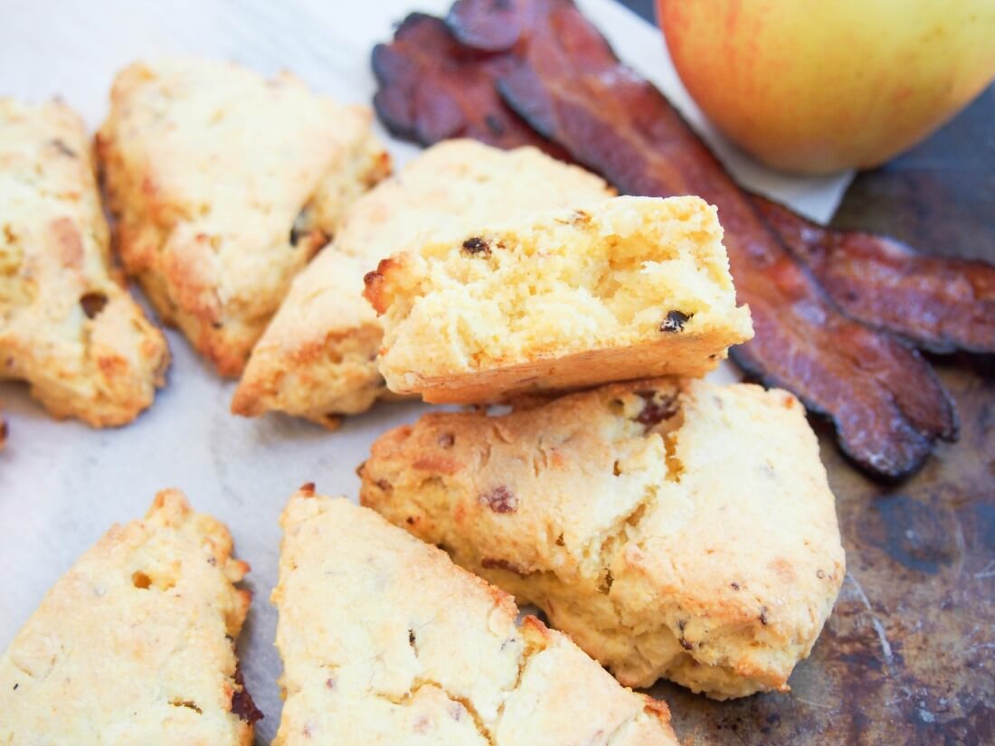 Apple and bacon cornmeal scones with one broken and resting on others