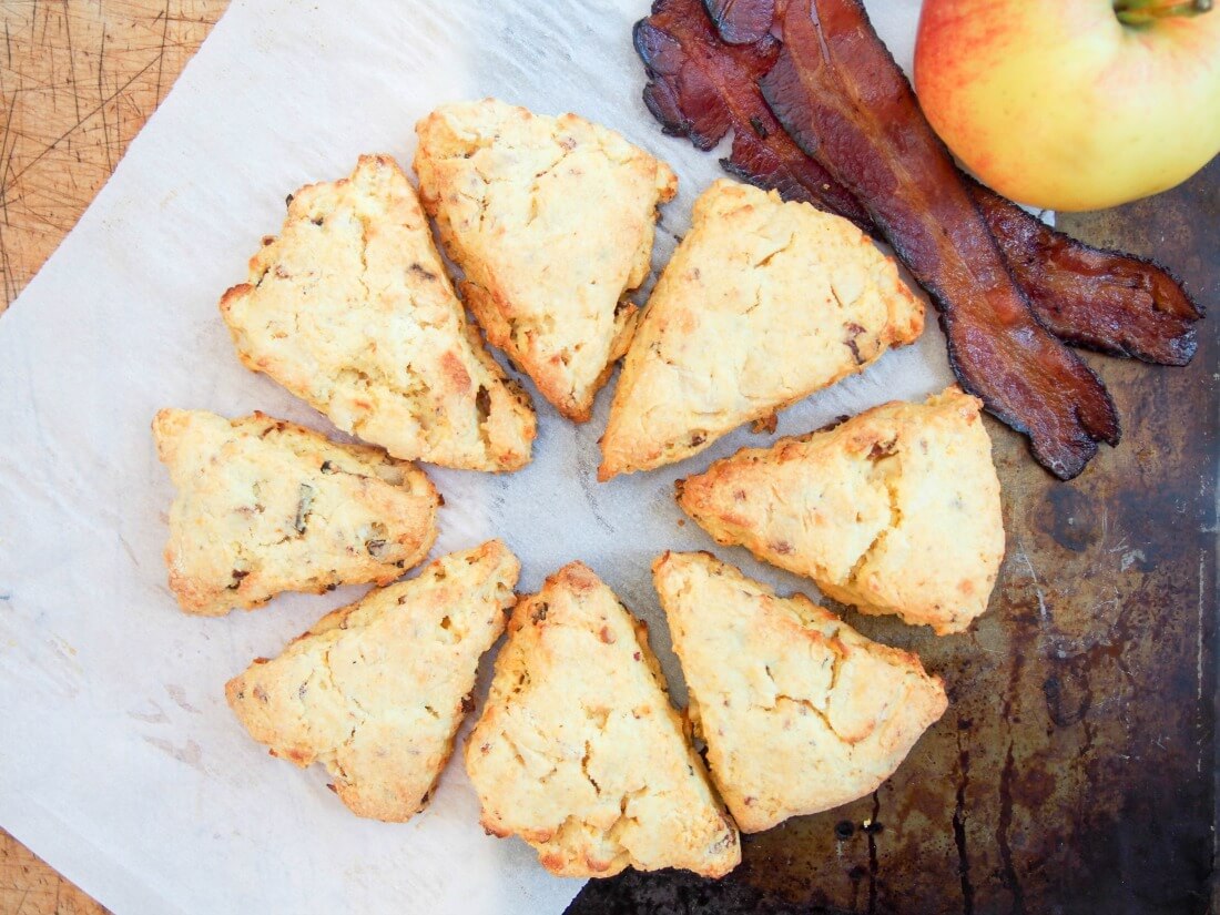Apple and bacon cornmeal scones with slices of bacon and apple to side