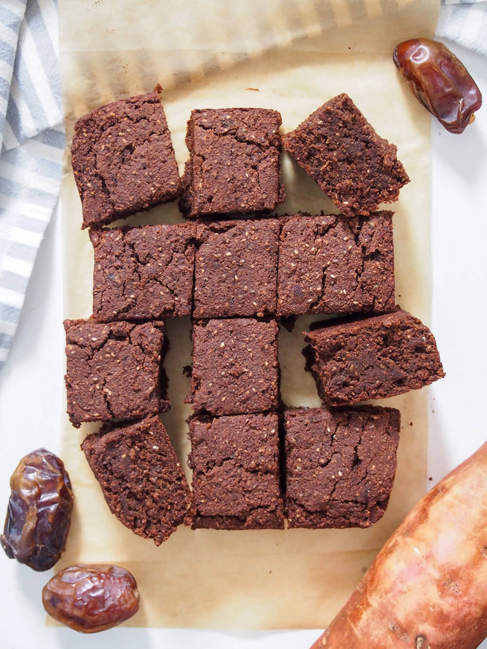 cut pieces of vegan sweet potato brownies on parchment from overhead