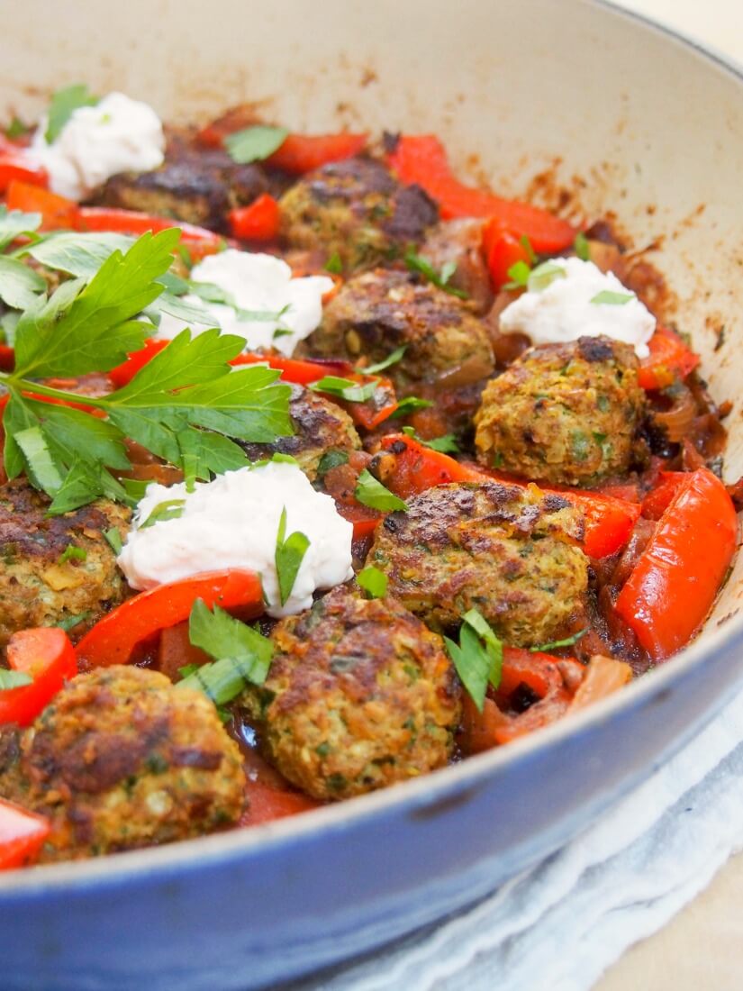 These kofte-style lamb meatballs are delicious with herbs, spices and pine nuts in them, made even better served in a tomato-pepper sauce with a feta-yogurt topping. 