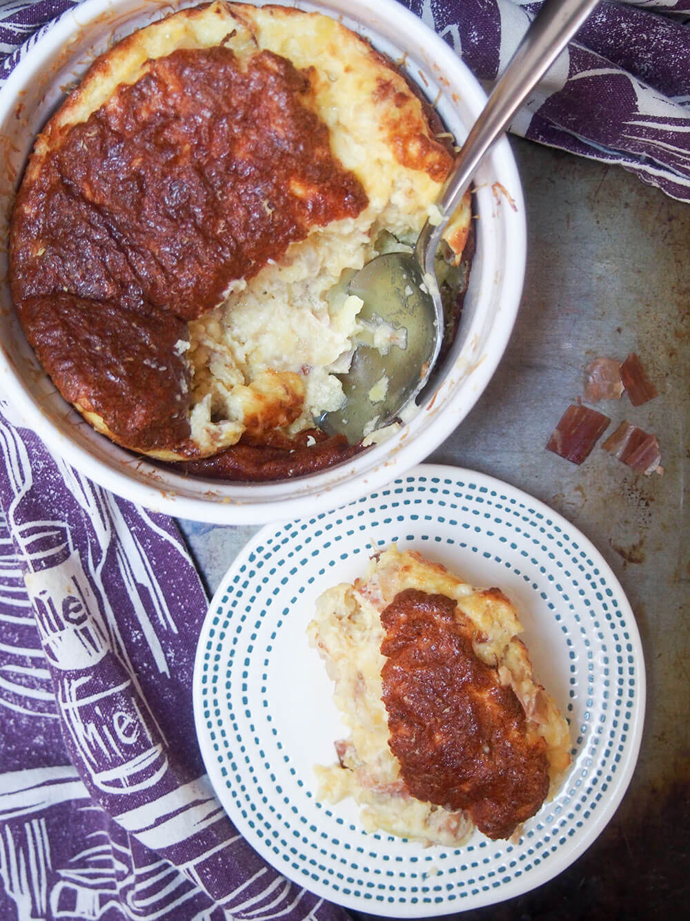 souffle viewed from overhead with spoonful taken out and served onto small plate